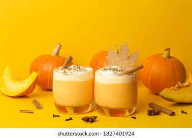 Pumpkin Latte Drink. Autumn Coffee With Spicy Pumpkin Flavor And Cream On A Yellow Background. Seasonal Fall Drinks For Halloween And Thanksgiving