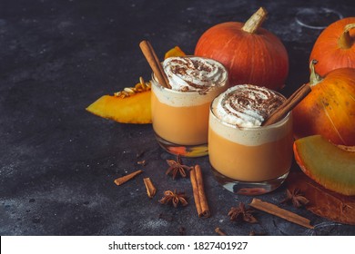 Pumpkin latte drink. Autumn coffee with spicy pumpkin flavor and cream on a dark background. Seasonal Fall Drinks for Halloween and Thanksgiving - Shutterstock ID 1827401927