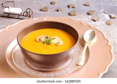 Pumpkin And Mushroom Soup On A Christmas Table