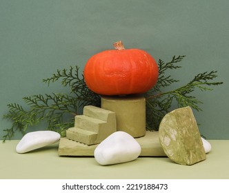 Pumpkin On A Podium With Plaster Geometric Shapes On A Two Tone Background. Creative Halloween Still Life