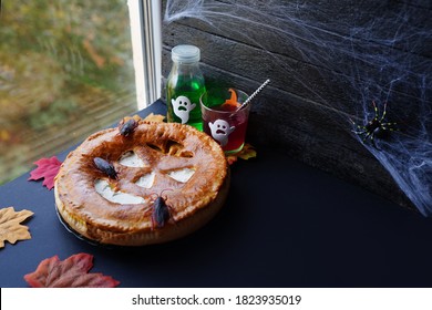 Pumpkin Pie With Multi Coloured Drinks On Window Sill. Autumn Seasonal Composition. Fall Time, Thanksgiving And Halloween Concept