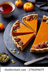 Pumpkin Pie On Marble Board With Cup Of Tea. Grey Background.