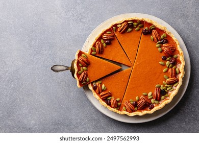 Pumpkin pie on a white plate. Grey background. Close up. Top view. - Powered by Shutterstock