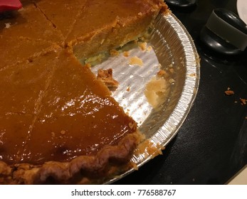 Pumpkin Pie In Tin With Slice Missing