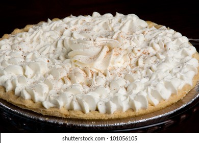 Pumpkin Pie/ Traditional Pumpkin Pie Topped With Whip Cream And Cinnamon.