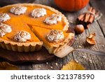 pumpkin pie with whipped cream and cinnamon on rustic background, top view