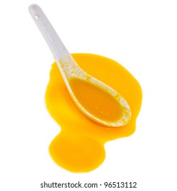 Pumpkin Puree The Soup Spilled From A White Spoon Isolated On White Background