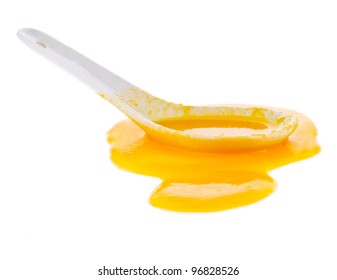 Pumpkin Puree The Soup Spilled From A White Spoon Isolated On White Background