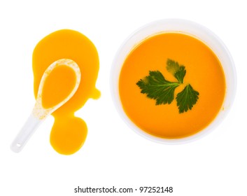 Pumpkin Puree Soup  And  Pumpkin Puree The Soup Spilled From A White Spoon Isolated On White Background