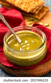 Pumpkin Seed Butter In A Glass Jar Close-up. Pumpkin Seed Paste. Vegan Food, Spread And Topping.