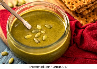 Pumpkin Seed Butter In A Glass Jar Close-up. Pumpkin Seed Paste. Vegan Food, Spread And Topping.