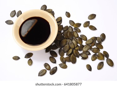 Pumpkin Seed Oil And Pumpkin Seeds Isolated Over White Background