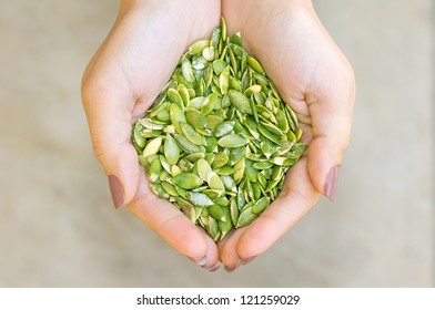 Pumpkin Seeds' Kernel In Woman Hands