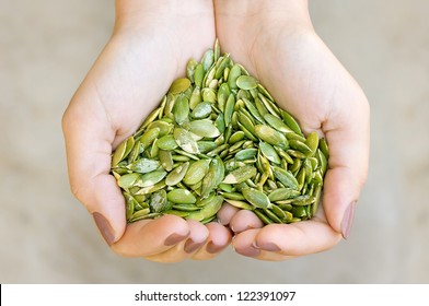 Pumpkin Seeds' Kernel In Woman Hands Forming Heart Shape