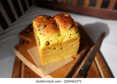 Pumpkin Shokupan Loaf Bread On A Wooden Board