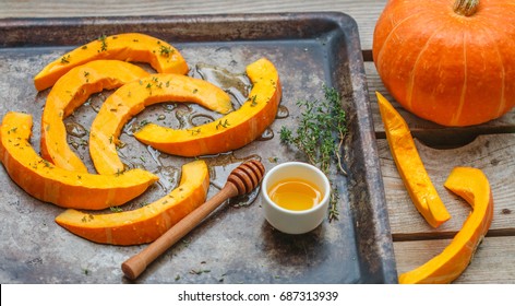 Pumpkin slices for baking with thyme and honey. Healthy dessert for gourmets. Selective focus