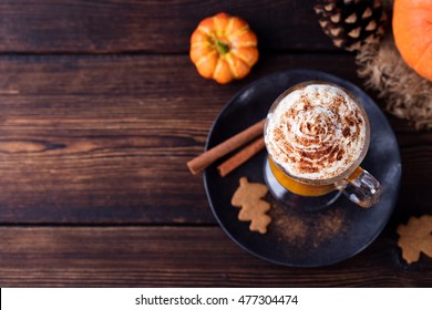 Pumpkin Smoothie, Spice Latte. Boozy Cocktail With Whipped Cream On Top On A Wooden Background. Copy Space Top View