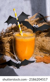 Pumpkin smoothie spiced latte. Fall Drinks for Halloween decorations with bat on straw. Holiday drink Autumn coffee with spicy pumpkin flavor seasonal hot drink. Vegan healthy dieting food Preparation - Shutterstock ID 2186204517