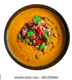 Pumpkin Soup In Black Plate Isolated On White Background