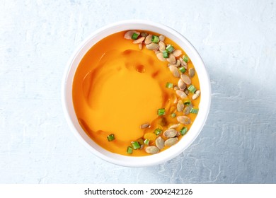 Pumpkin Soup With Seeds And Scallions. Vegan Butternut Squash Cream Soup, Healthy Dinner, Overhead Shot