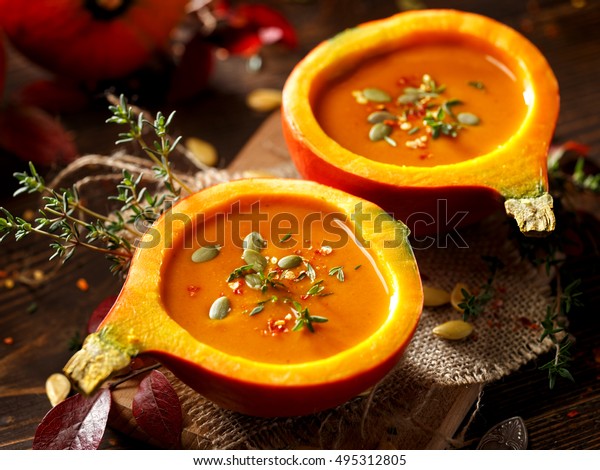 Pumpkin soup served in\
a hollowed pumpkins