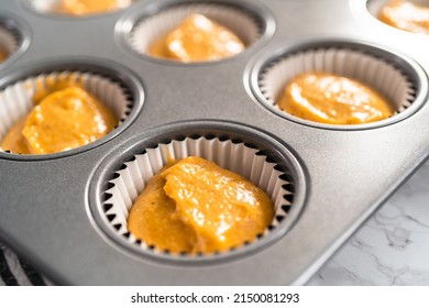 Pumpkin Spice Cupcake Batter In A Cupcake Pan With Liners.