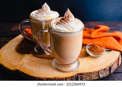 Pumpkin Spice Hot Chocolate Topped with Whipped Cream: Mugs of hot chocolate topped with chantilly cream and pumpkin spice - Powered by Shutterstock