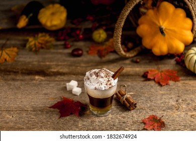 Pumpkin Spice Latte With Cinamon Powder And Delicious Flavours On The Old Textured Wood Table With Colorful Dry Leaves And Pumpkins