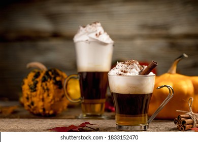 Pumpkin Spice Latte With Cinamon Powder And Delicious Flavours On The Old Textured Wood Table With Colorful Dry Leaves And Pumpkins