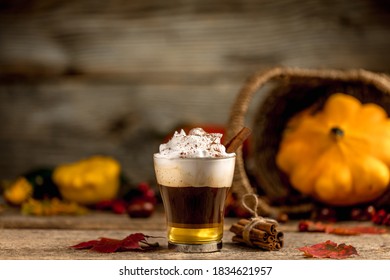 Pumpkin Spice Latte With Cinamon Powder And Delicious Flavours On The Old Textured Wood Table With Colorful Dry Leaves And Pumpkins