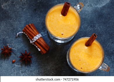 Pumpkin spice latte, hot coffee drink with pumpkin and cinnamon top view