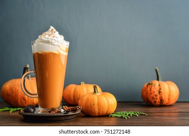 Pumpkin Spice Latte With Whipped Cream On Wooden Background