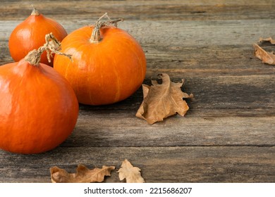 Pumpkin, Squash. Happy Thanksgiving Day Wooden Table, Background Decorated With Pumpkins And Autumn Leaves Garland. Holiday Autumn Festival Scene, Fall, Harvest. Halloween