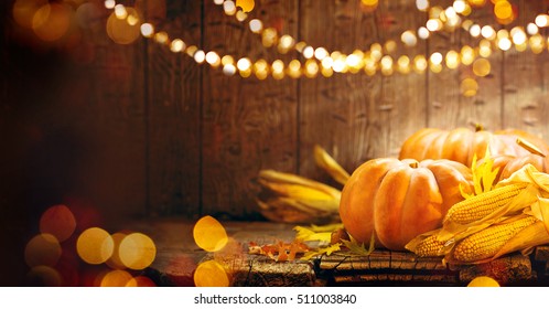 Pumpkin, Squash. Happy Thanksgiving Day Background. Autumn Thanksgiving Pumpkins over wooden background with garland still-life. Beautiful Holiday Autumn festival concept scene Fall, Harvest. 