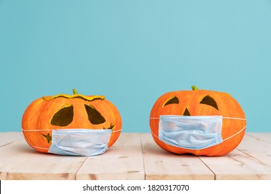 Pumpkins in face masks on teal color background. Preparing for Halloween in Covid-2019 time.  - Powered by Shutterstock