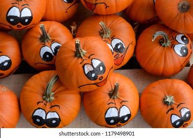 Pumpkins with funny face drawn on them sold for Halloween and Harvest festival in Salzburg, Austria