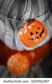 Pumpkins and jack-o'-lantern lights, closeup view. Halloween decorations