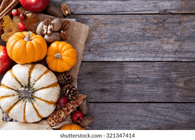 Pumpkins, Nuts, Indian Corn And Apples On A Rustic Table Overhead Corner Frame With Empty Space