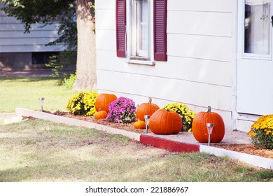 Pumpkins On Front Steps Of Home During Halloween/Thanksgiving Season 