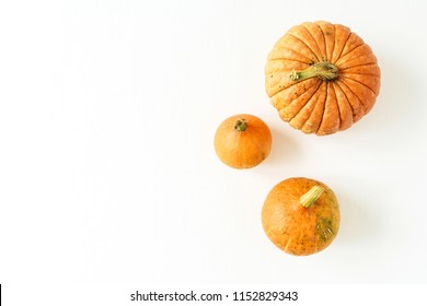 Pumpkins On White Background. Fall Autumn Halloween Concept. Flat Lay, Top View.