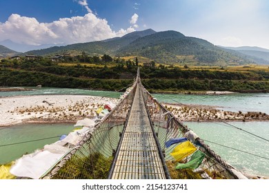 The Punakha Suspension Bridge at the Punakha Dzong. Across the Tsang Chu River to Shengana and Wangkha village. The longest suspension bridge in Bhutan and always decorated with colorful prayer flags. - Shutterstock ID 2154123741