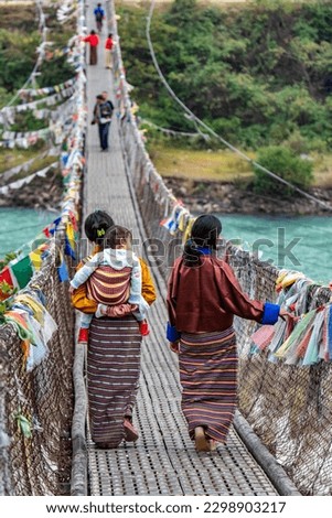 The Punakha Suspension Bridge at the Punakha Dzong is an important part of the architectural history of Bhutan. The longest suspension bridge in Bhutan and always decorated with colorful prayer flags.