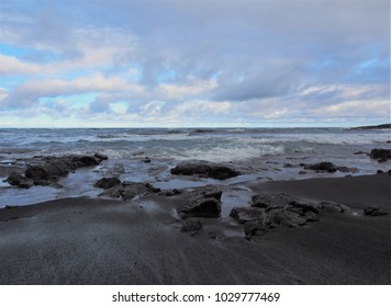 Punalu'u Black Sand Beach with Calm Waves, Rocks, and Cloudy Blue Sky, The Big Island, Hawaii - Powered by Shutterstock