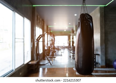Punch bag at fitness center club with training exercise boxing sandbag. Modern gym interior with equipment. Workout with sport boxer for training or burn callories the for sport boxing concept.