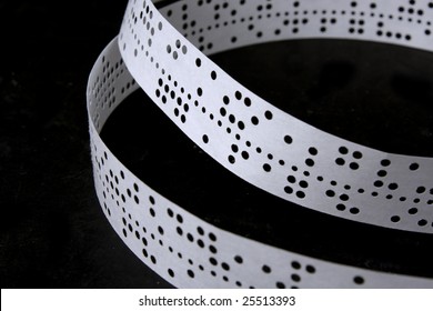 The Punched Tape On A Black Background Lays Rings