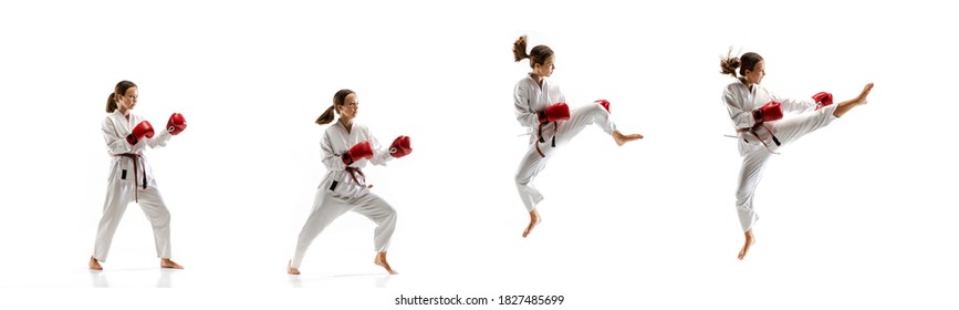 Punching. Junior in kimono practicing taekwondo combat, martial arts. Young female fighter with red gloves training on white studio background in motion, dymanic. Concept of healthy lifestyle, action.