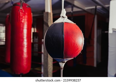 Punching and speed bags in boxing gym hanging, red and black, no people - Powered by Shutterstock