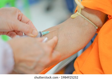 Puncture Of A Vein Through The Skin In Order To Withdraw Blood For Analysis.the Specialist Uses A Syringe To Venipuncture From Patient's Arm. Selective Focus                               