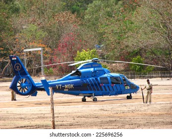 Pune, India - June 01, 2008: A Lone Police Officer With Gun Guards An Indian Government Helicopter / Chopper.