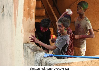 PUNE, INDIA- March 20, 2018, Kids Playing HOLI Indian Color Festival. Throwing Water Balloons 